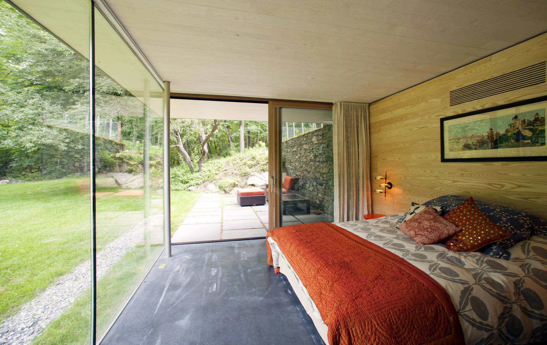 Bedroom With Glass Walls And Green Views
