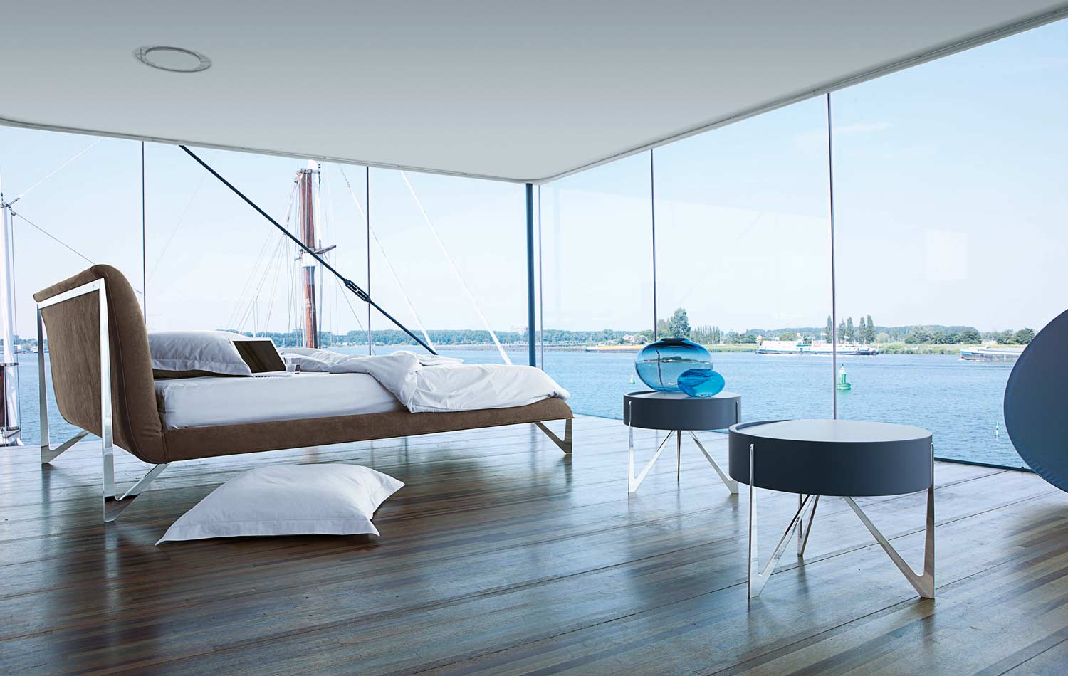 Bedroom With A Glass Wall And Ocean View