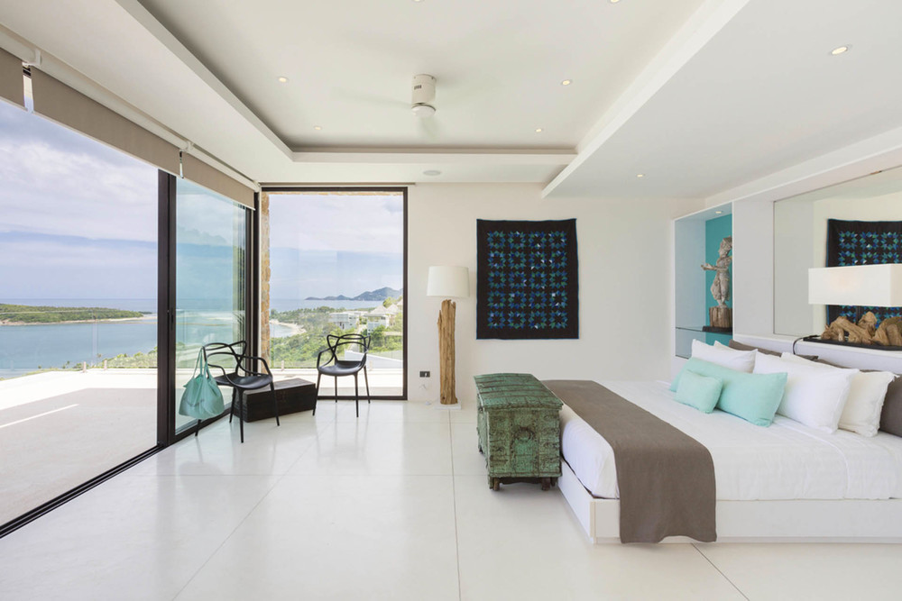 Spacious Bedroom With A Floor-To-Ceiling Glass Front Wall