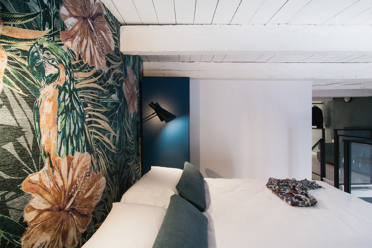 Loft Bedroom With Tropical Featured Wall