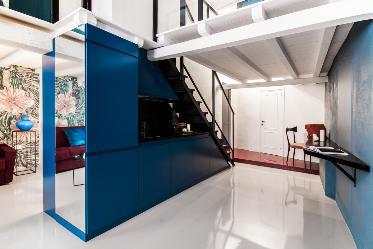 Dark Blue Kitchen That Serves As A Divider