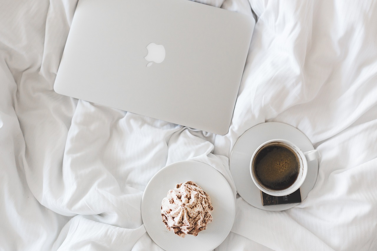 Laptop And Coffee On The Bed