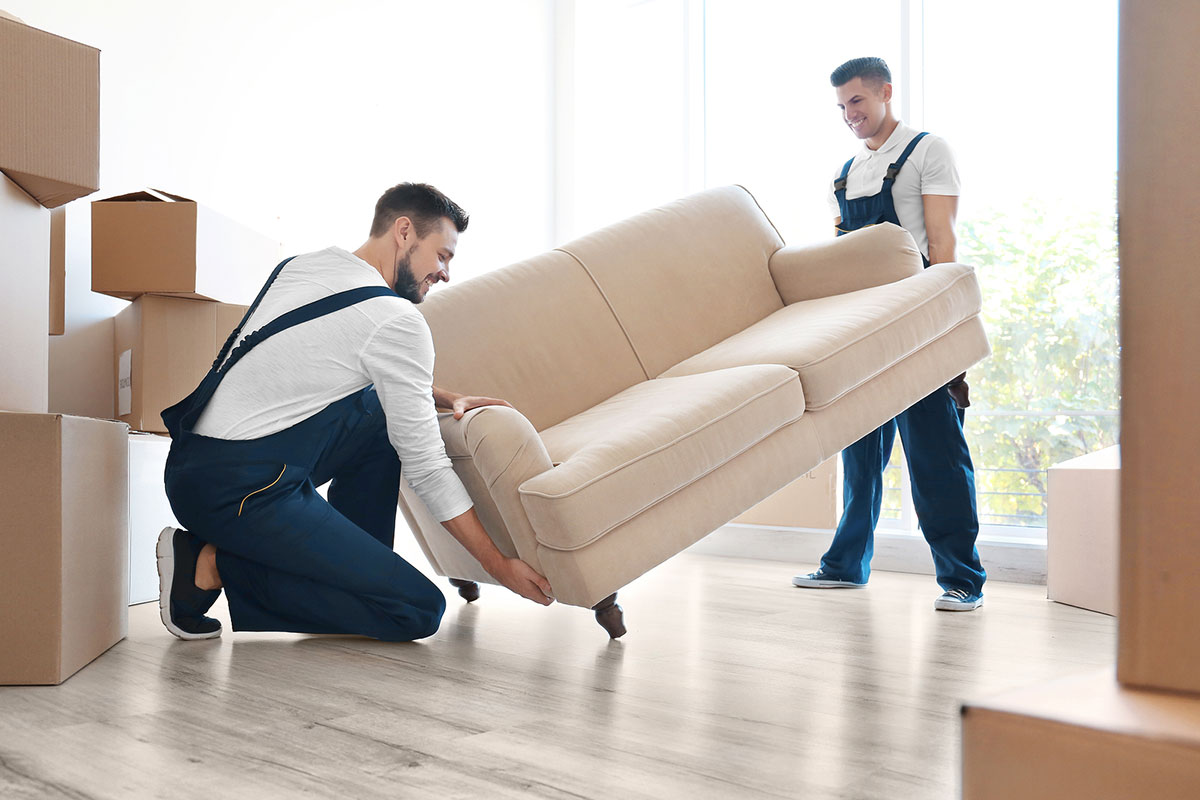 Two Men Moving A Sofa