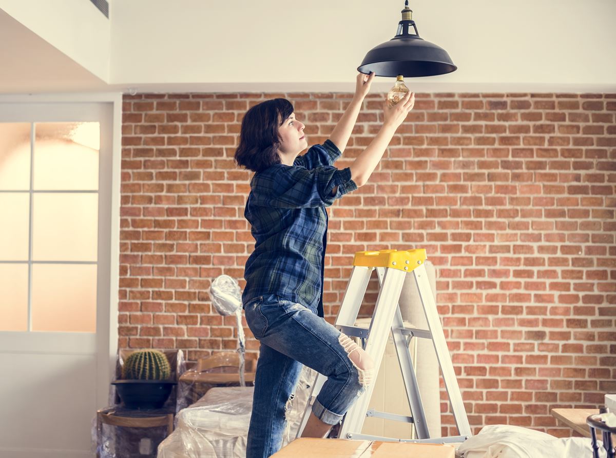 Woman Changing Lightbulb